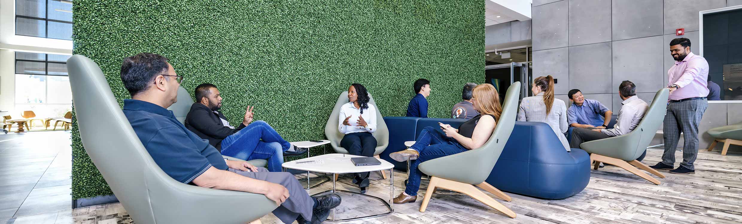 Employees sitting and talking in groups in a courtyard
